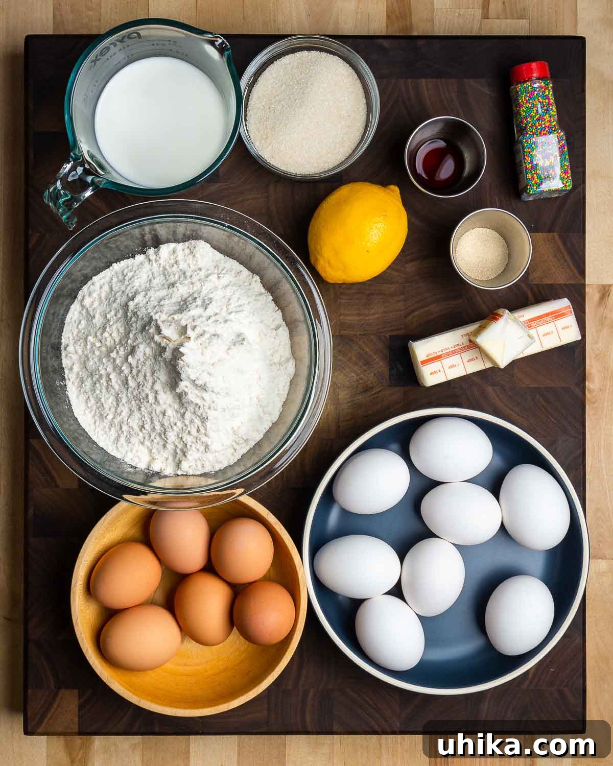 Italy's Festive Pasqua Bake 3 Ingredients shown: milk, sugar, vanilla, lemon, Diastatic malt powder, sprinkles, flour, butter, and eggs.