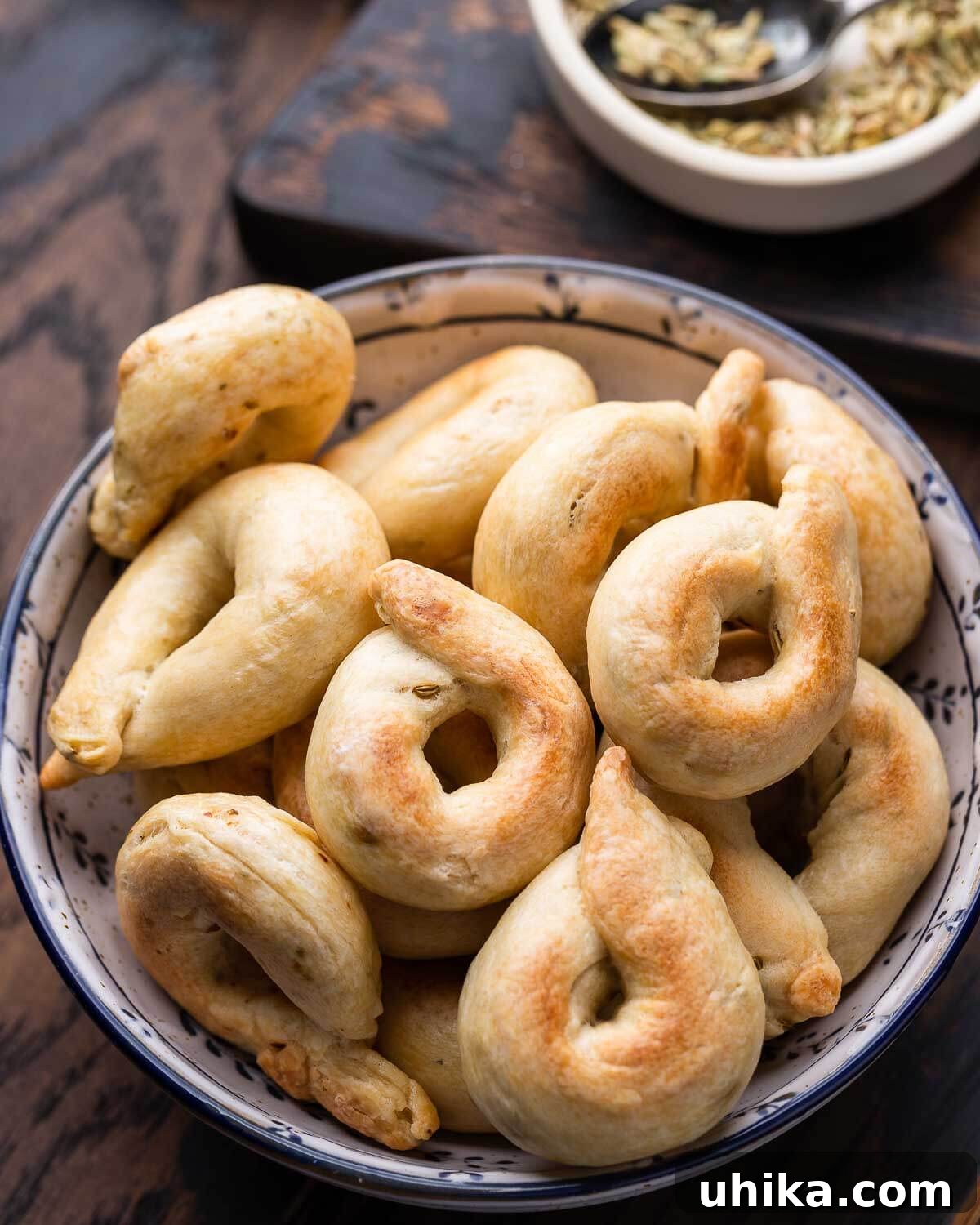 Taralli 2 A bowl filled with freshly baked, golden-brown fennel seed taralli, ready to be served.