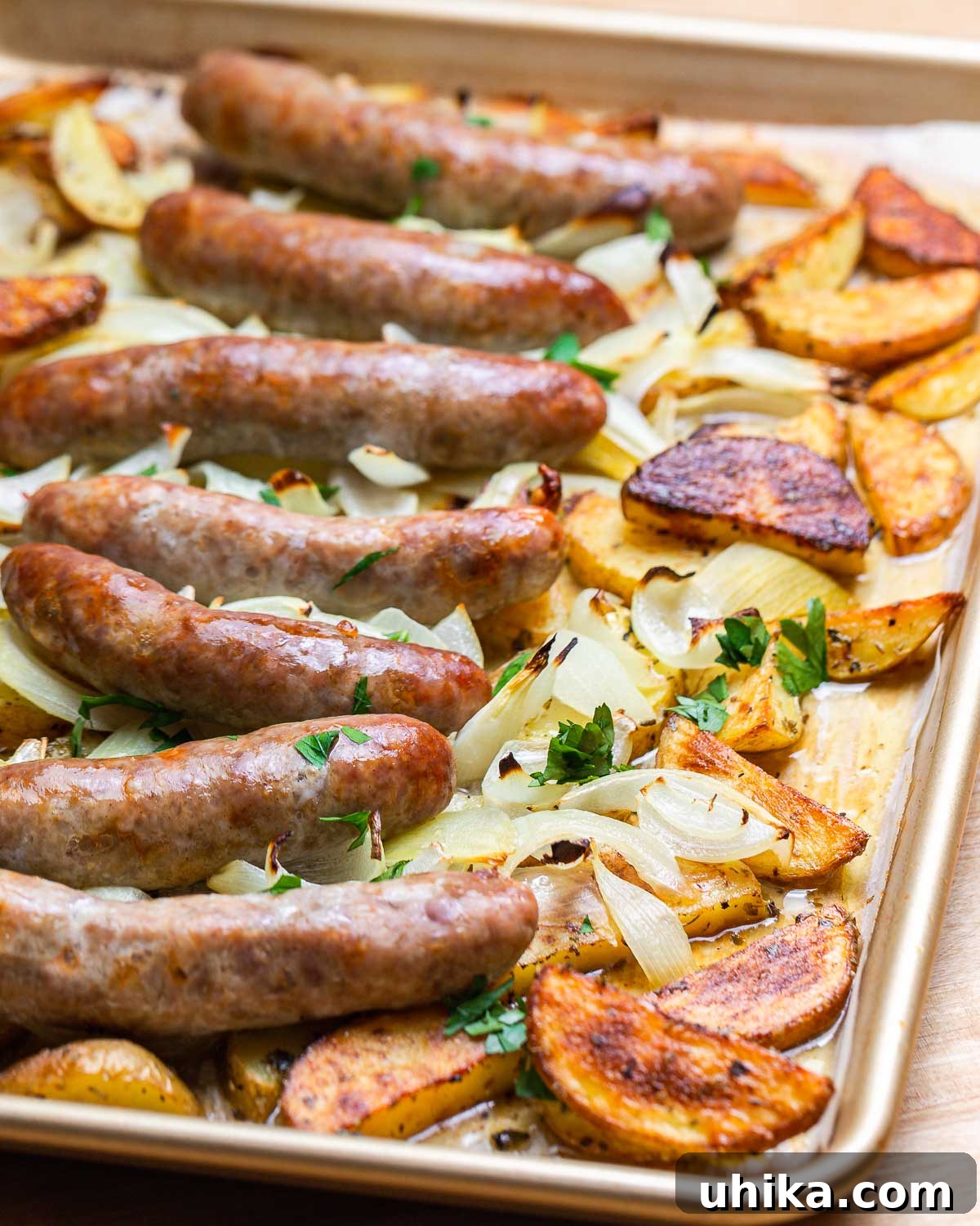 Rustic Italian Sausage and Potato Bake 2 Golden pan with cooked roasted potatoes and Italian sausage, ready to serve.