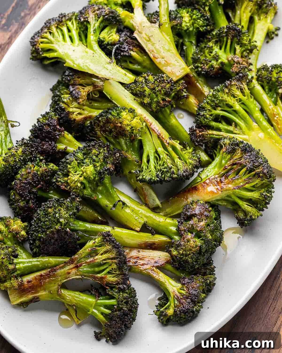 Crispy Roasted Broccoli 2 Overhead shot of perfectly roasted broccoli florets served in a elegant grey platter, ready to be enjoyed as a side dish or light meal.