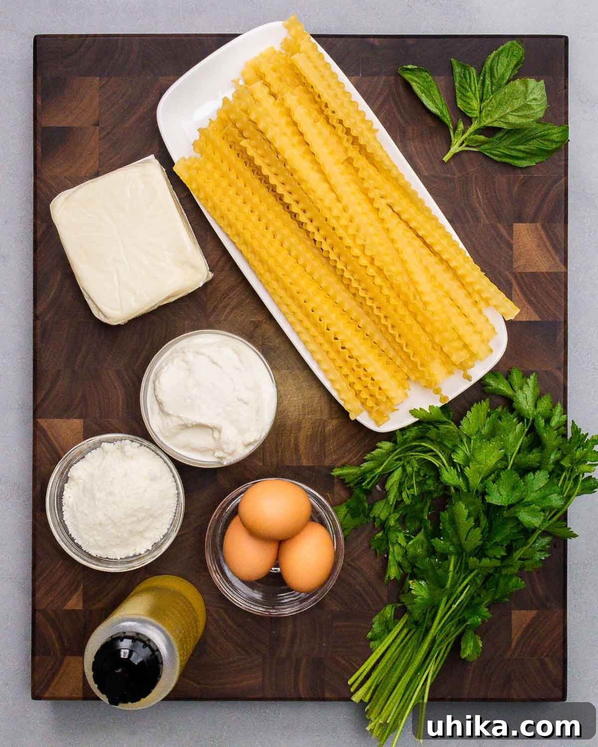 Lasagna Torte 4 Ingredients shown: mozzarella, mafaldine, basil, ricotta, Pecorino, olive oil, eggs, and parsley.