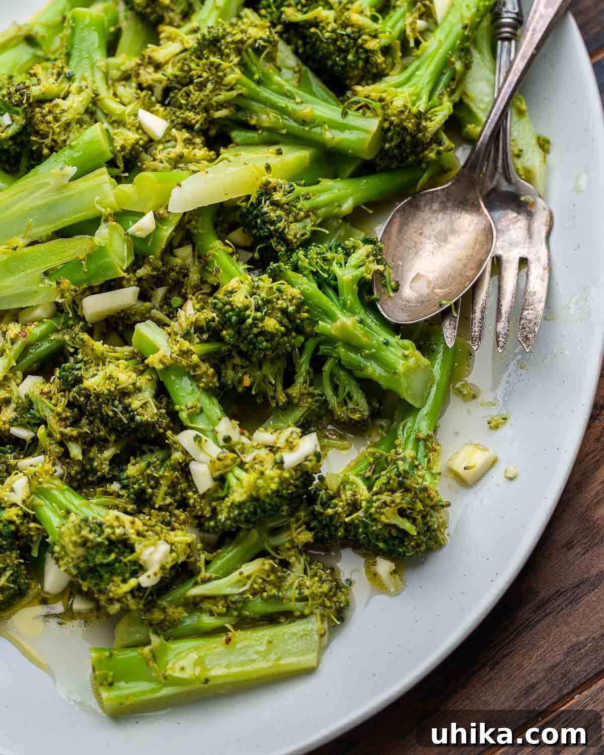 A vibrant close-up shot of the Italian broccoli salad, highlighting the tender green florets coated in the zesty lemon-garlic dressing, showcasing its appetizing texture and fresh ingredients.