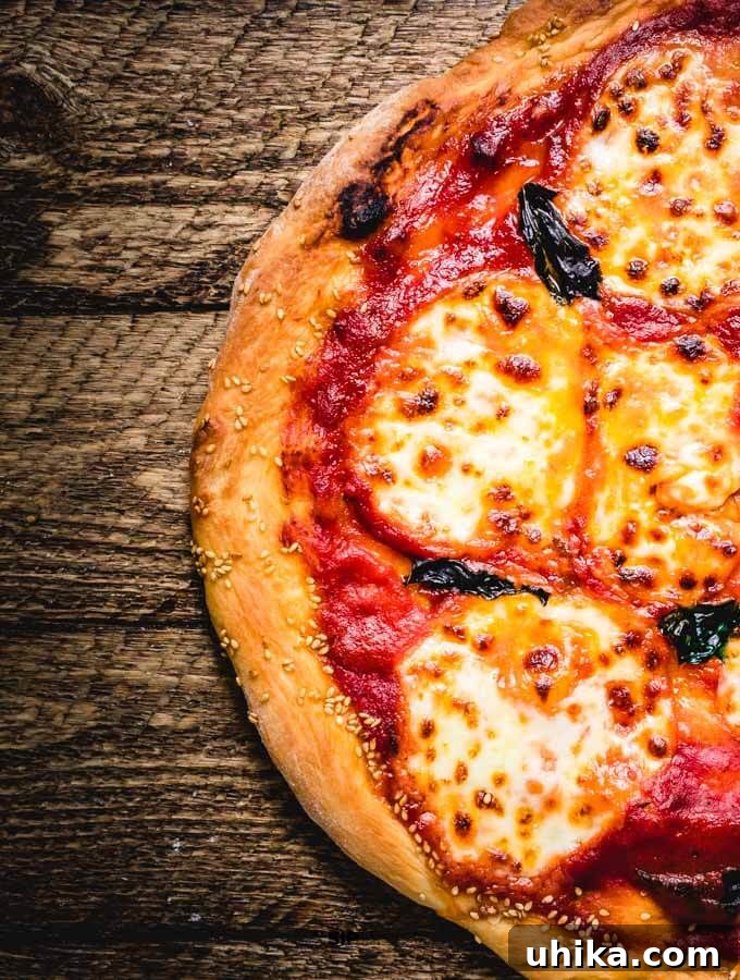 Perfectly Baked Margherita Pizza Close up of a freshly baked Margherita pizza, showcasing the bubbling mozzarella, charred crust, and vibrant basil.