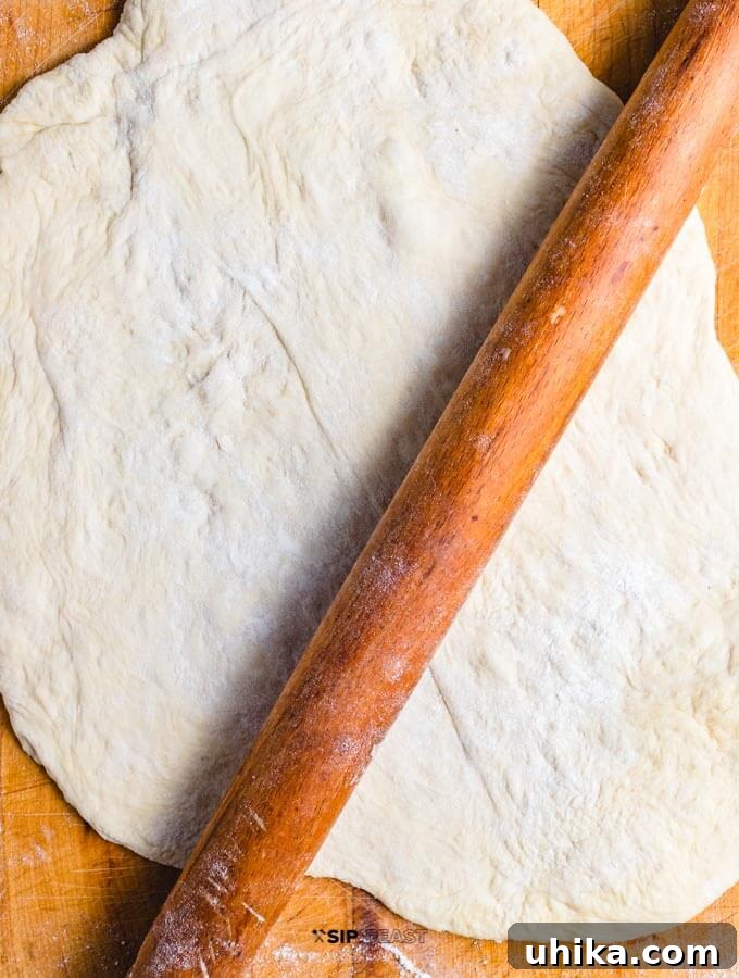 Shaping Pizza Dough Rolled out store-bought pizza dough on a cutting board, ready for toppings.