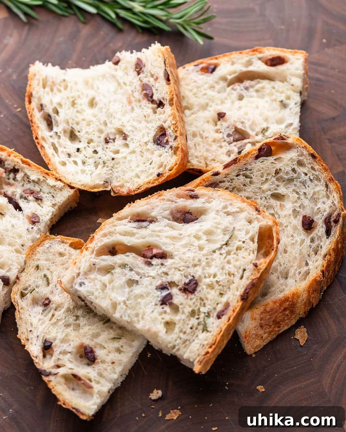 Mediterranean Olive Bread 9 Cut up small pieces of olive bread on walnut cutting board.