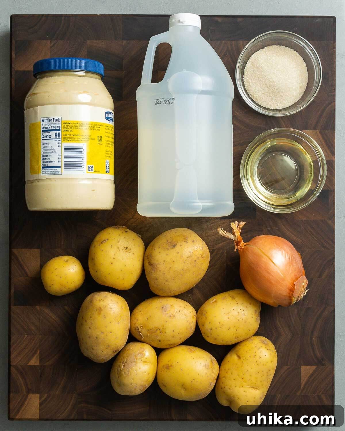 Iconic New York Deli Potato Salad 3 Recipe ingredients shown: mayonnaise, vinegar, sugar, vegetable oil, potatoes, and onion.