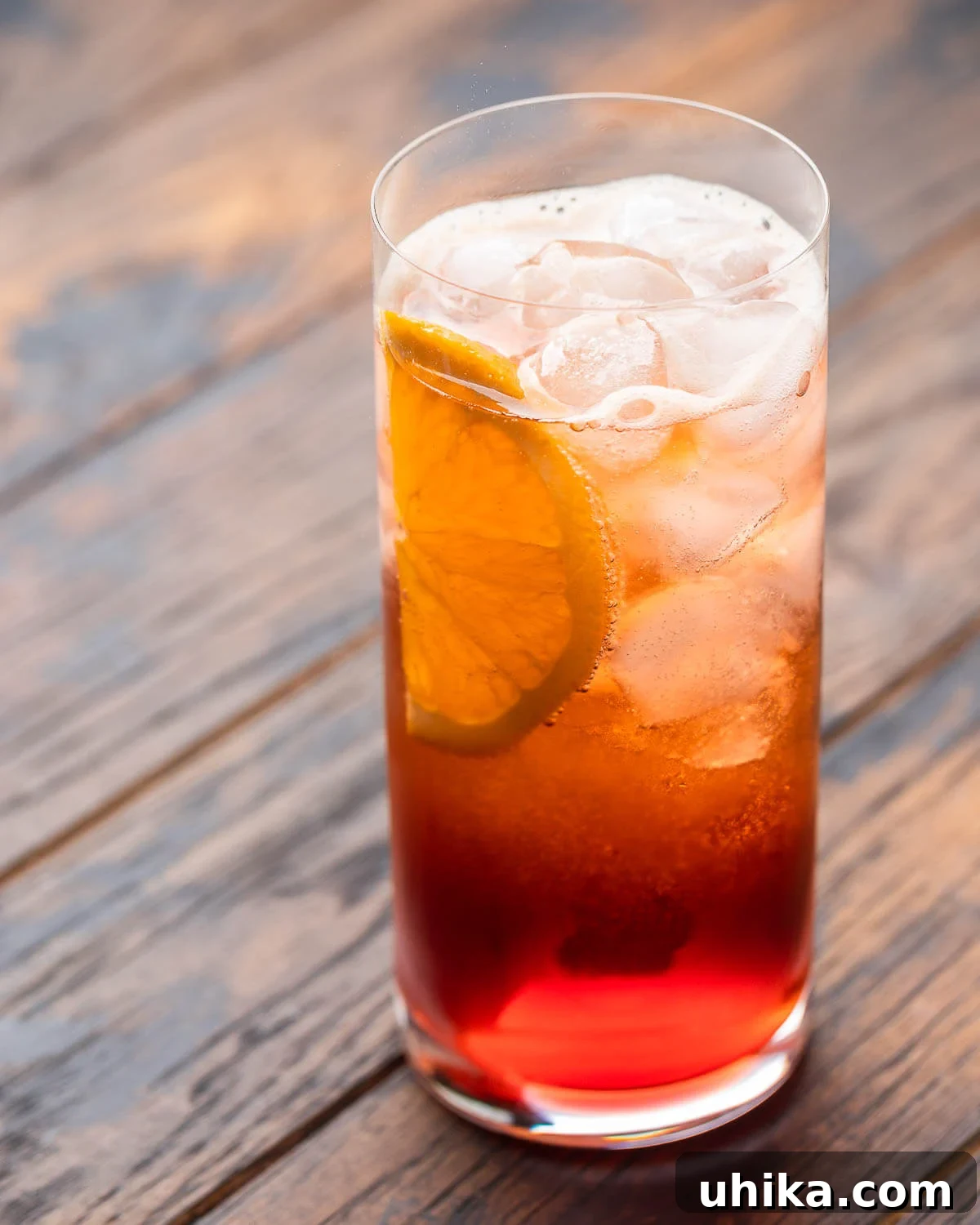 Highball glass with Americano cocktail in sunlight.
