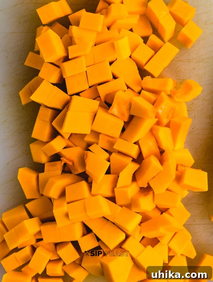 Roasted Poblano Peppers and Stewed Butternut Squash Chili - The Ultimate Fall Comfort Food Chopped butternut squash on cutting board.