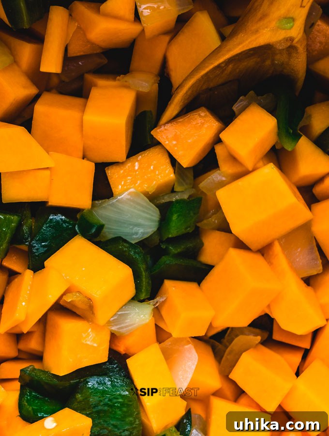 Roasted Poblano Peppers and Stewed Butternut Squash Chili - The Ultimate Fall Comfort Food Roasted poblano peppers with stewed butternut squash in pot.