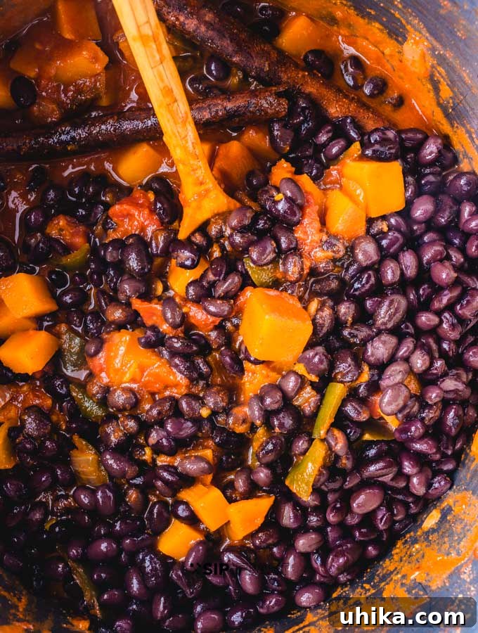 Roasted Poblano Peppers and Stewed Butternut Squash Chili - The Ultimate Fall Comfort Food Adding the black beans to chili pot.