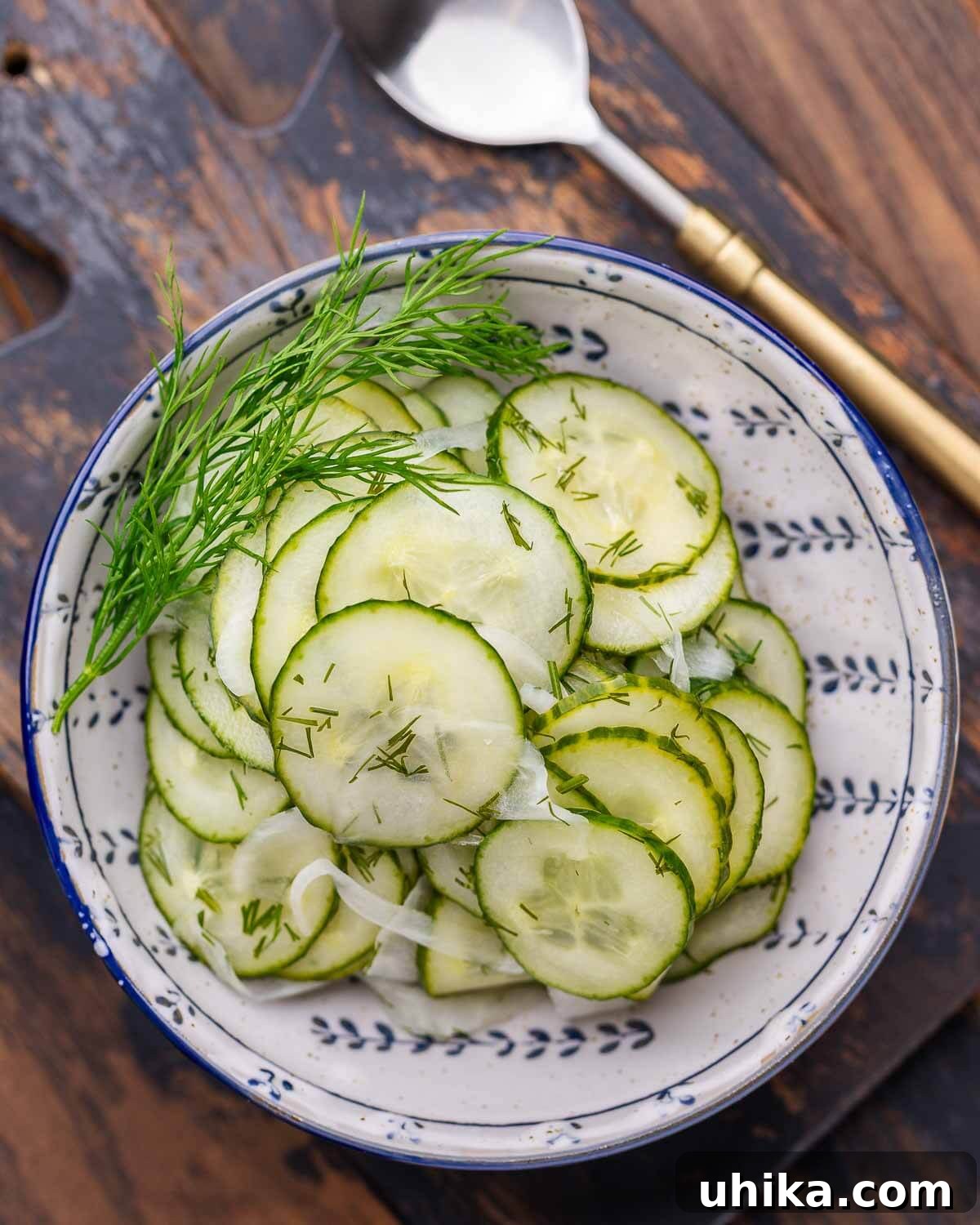 Crisp Cucumber Cool-down 2 Closeup shot of refreshing cucumber salad in a blue and white bowl, garnished with fresh dill.