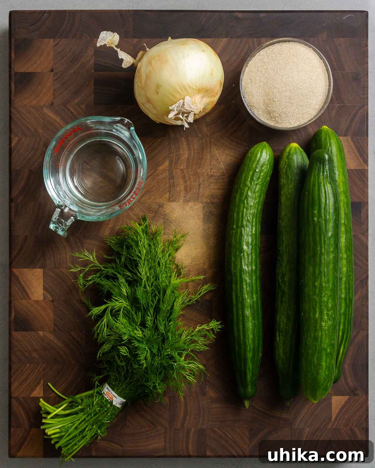 Crisp Cucumber Cool-down 3 Fresh ingredients for New York deli cucumber salad: sweet onion, granulated sugar, white vinegar, fresh dill, and crisp English cucumbers.