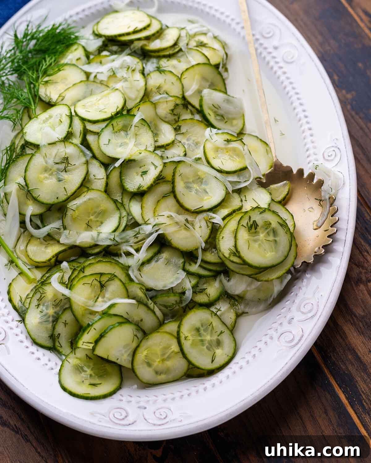 Crisp Cucumber Cool-down 6 Overhead shot of a white platter filled with classic New York deli cucumber salad.
