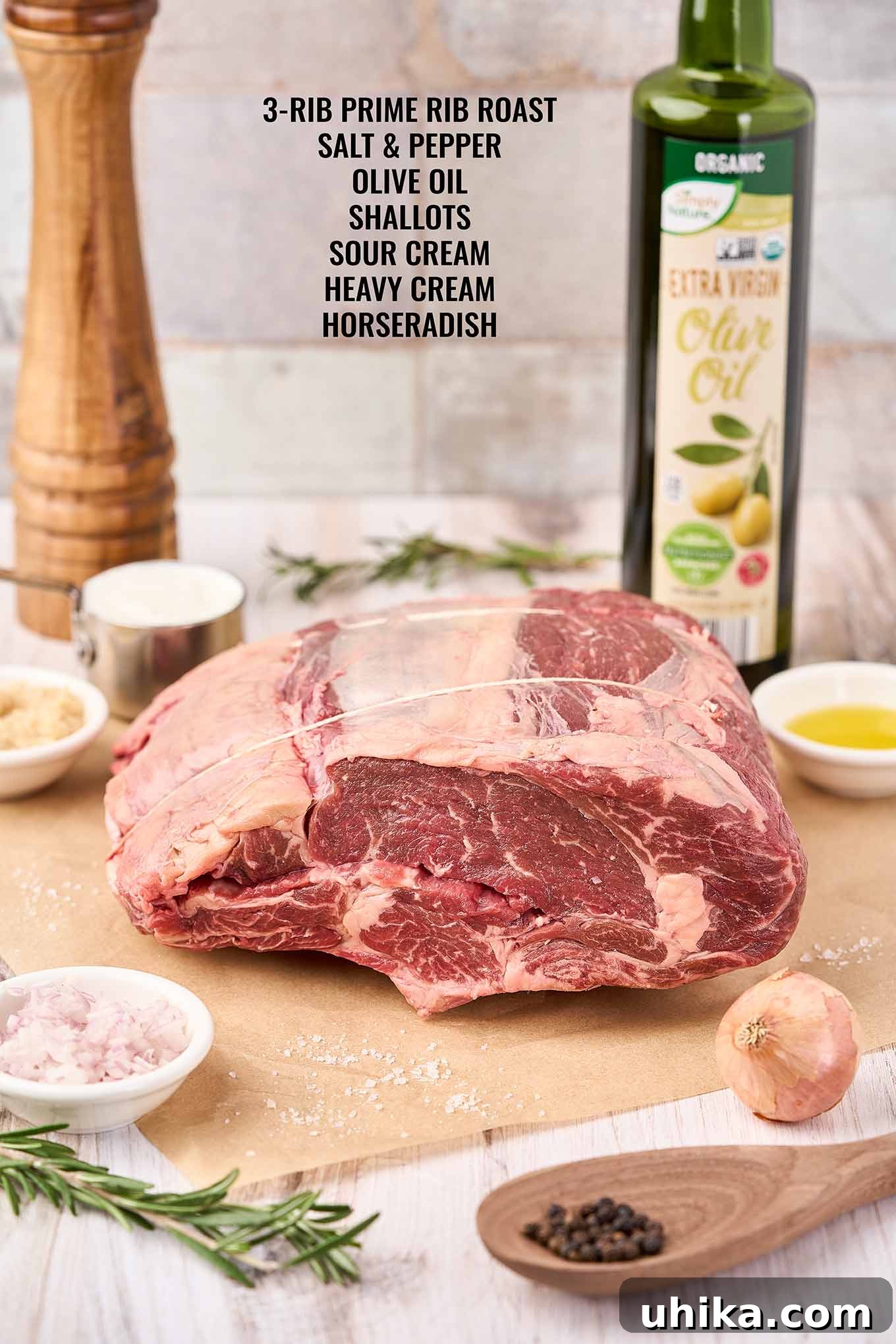 Mastering the Perfect Prime Rib 3 All the ingredients neatly laid out: a 3-rib prime rib roast, fresh shallots, high-quality olive oil, coarse kosher salt, freshly ground black pepper, sour cream, and prepared horseradish for the perfect holiday meal.