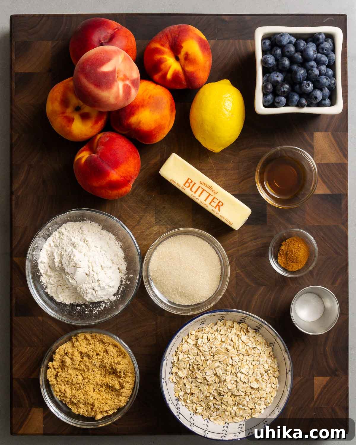 Sun-Kissed Peach and Blueberry Crumble 3 Ingredients shown: fresh peaches, lemon, blueberries, all-purpose flour, granulated sugar, cold unsalted butter, vanilla extract, ground cinnamon, sea salt, brown sugar, and old-fashioned rolled oats.