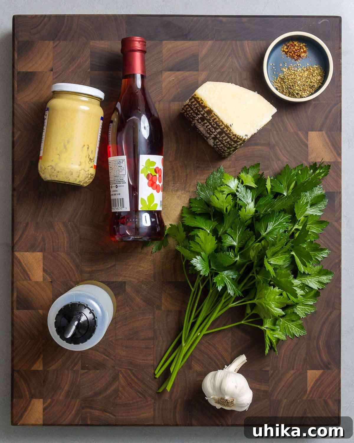 Zesty Italian Vinaigrette 3 Ingredients shown: Dijon mustard, red wine vinegar, Pecorino, oregano, hot red pepper flakes, extra virgin olive oil, parsley, and garlic.