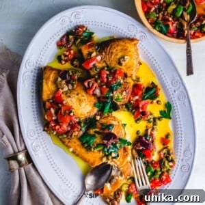 Pan seared swordfish steaks with olives and capers featured recipe card image.