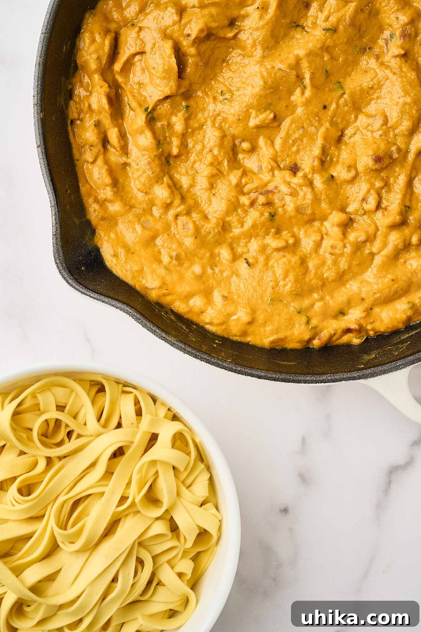Golden Pumpkin Pasta with Crispy Pancetta and Creamy Parmesan 6 Final step for preparing creamy pumpkin pasta, pumpkin mixture in a skillet ready to be combined with cooked fettuccine.