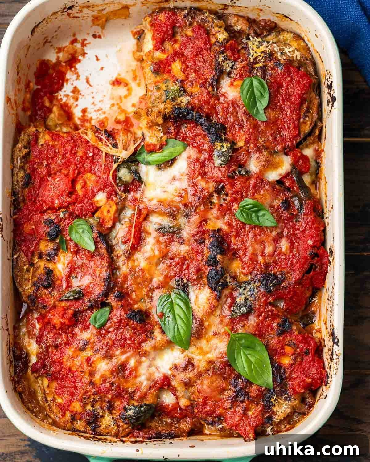 Golden Baked Eggplant Parmesan 2 Overhead shot of Neapolitan style eggplant parmigiana in baking dish.