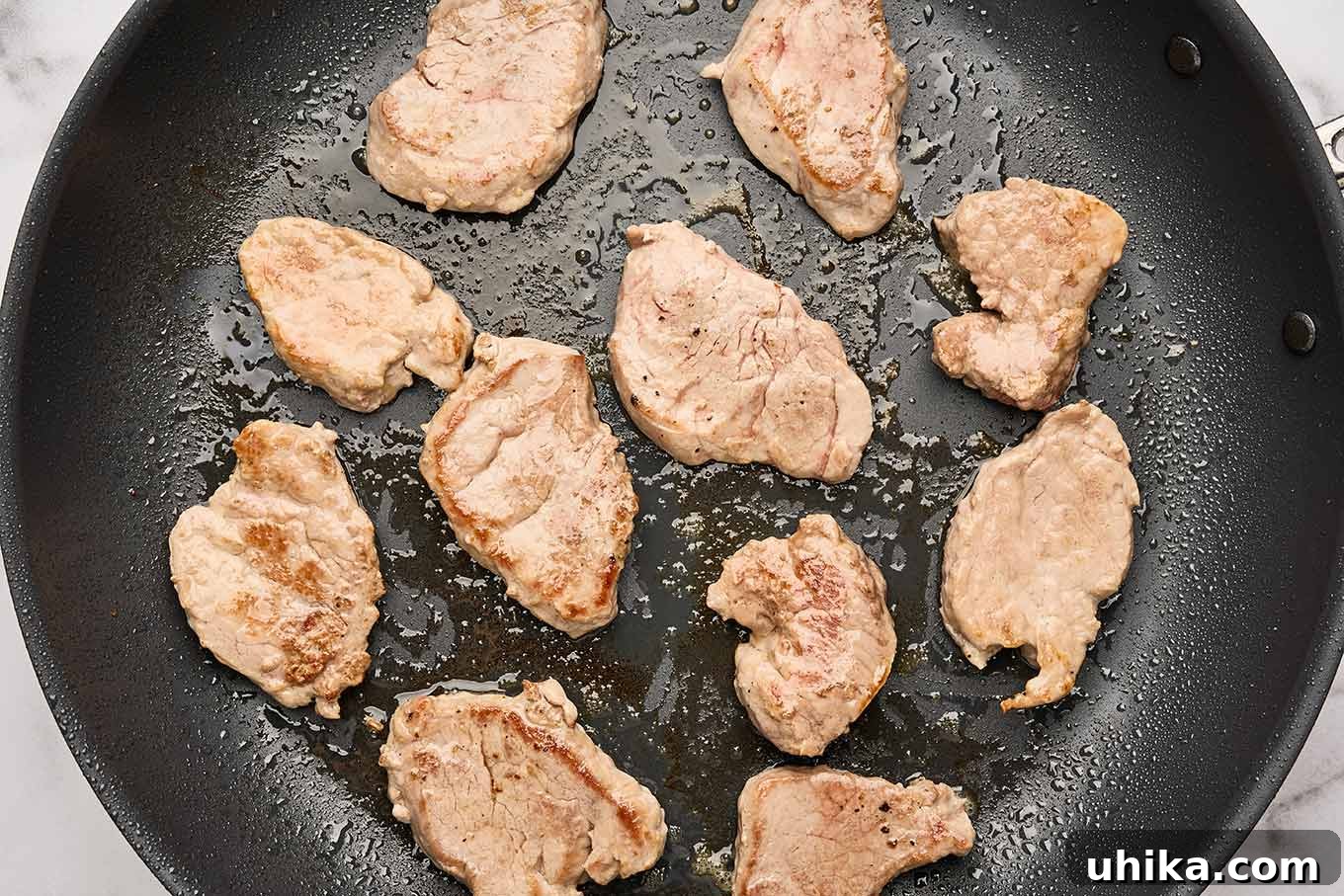 Maple Mustard Glazed Pork Tenderloin Sliders 4 Close-up shot of pork tenderloin medallions being quickly seared in a hot skillet until lightly browned, creating a delicious crust and locking in juices, a crucial step for flavorful sliders.