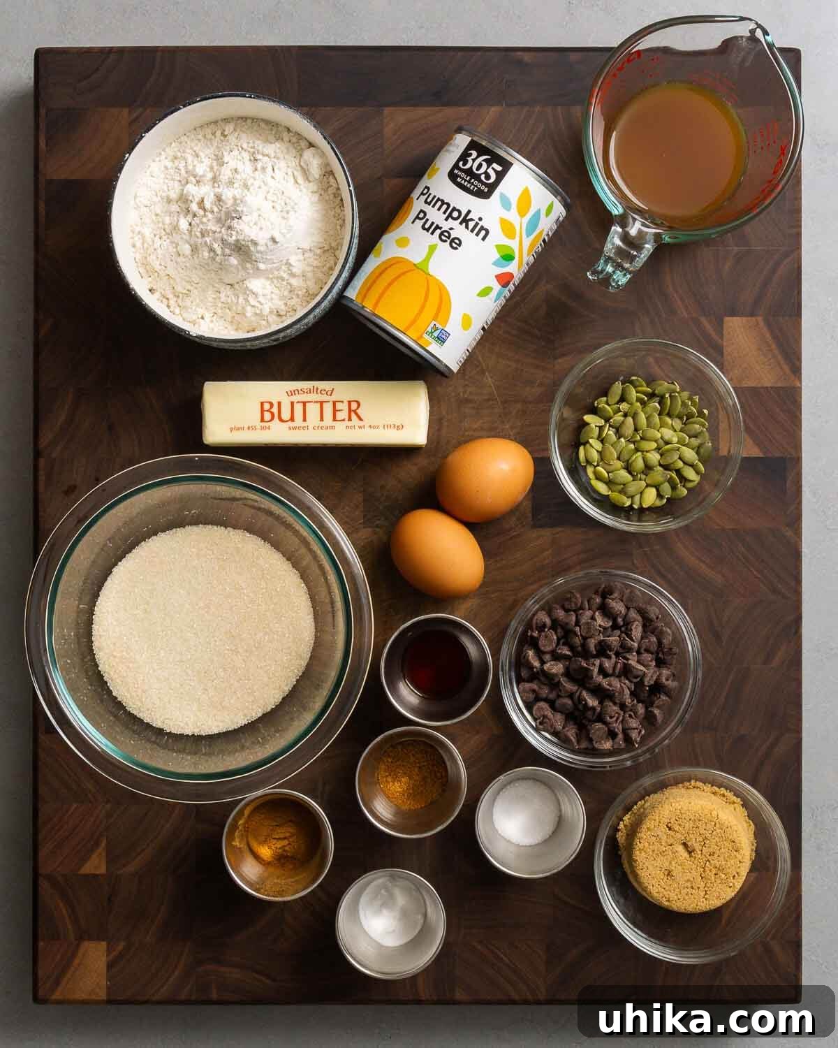 Golden Pumpkin Spice Bread 3 Ingredients for pumpkin bread: flour, pumpkin puree, apple cider, butter, eggs, pumpkin seeds, sugar, vanilla, cinnamon, baking soda, salt, brown sugar, and chocolate chips.