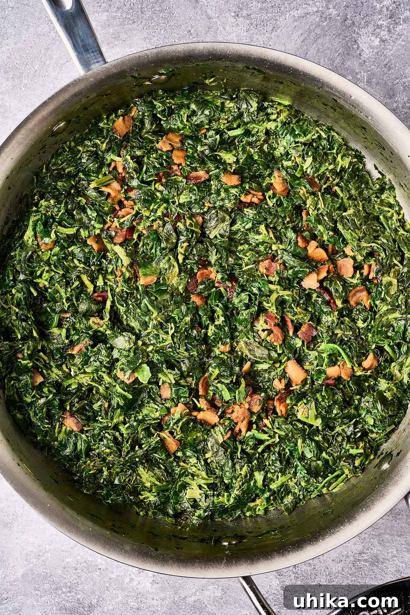 Crispy Bacon and Tangy Spinach Delight 5 A sauté pan filled with chopped spinach combined with sugar, apple cider vinegar, butter, cream, and bacon bits.