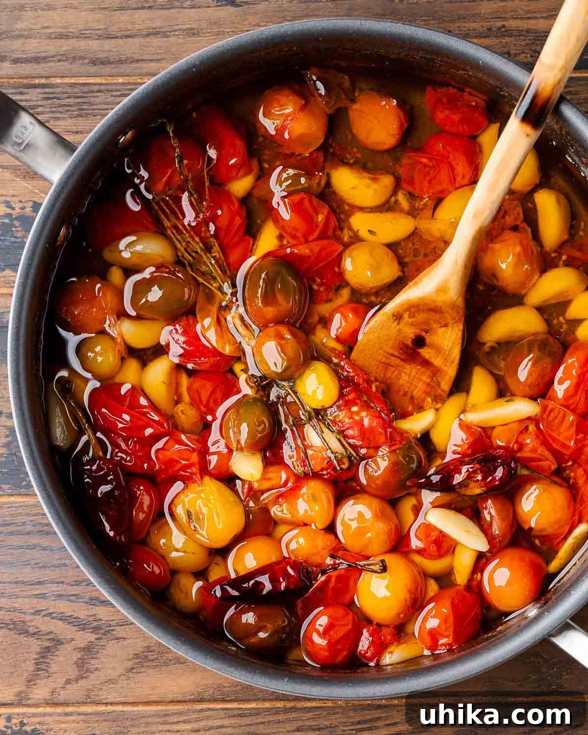 Rich Roasted Tomato Jewels 2 A large pan filled with vibrant red tomato garlic confit, ready to be served.