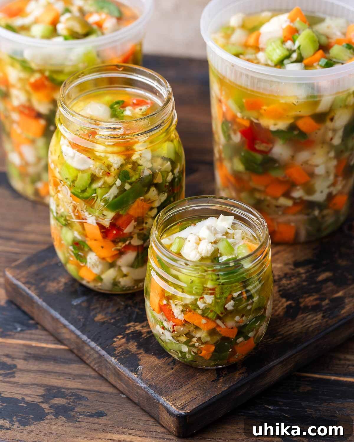 Zesty Garden Relish 2 Quart containers and mason jars filled with giardiniera on wooden table, showcasing the vibrant colors of the pickled vegetables.