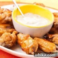 A close-up of golden-brown tequila-marinated chicken wings.