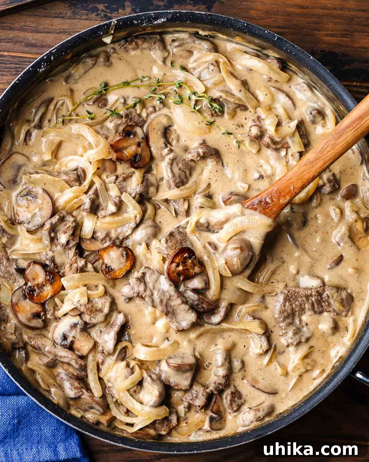 Velvety Beef Stroganoff 7 Overhead shot of black pan with beef stroganoff.