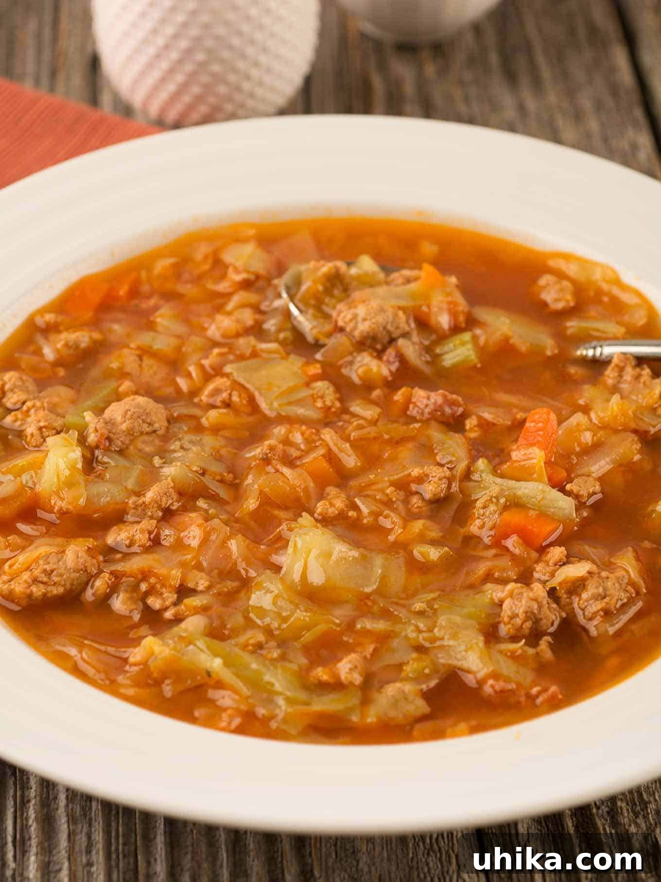 Quick Cabbage Comfort 4 A serving bowl of pressure cooker (Instant Pot) cabbage soup with crumbled ground turkey, smoked sausage, and cabbage in a tomato-based broth.