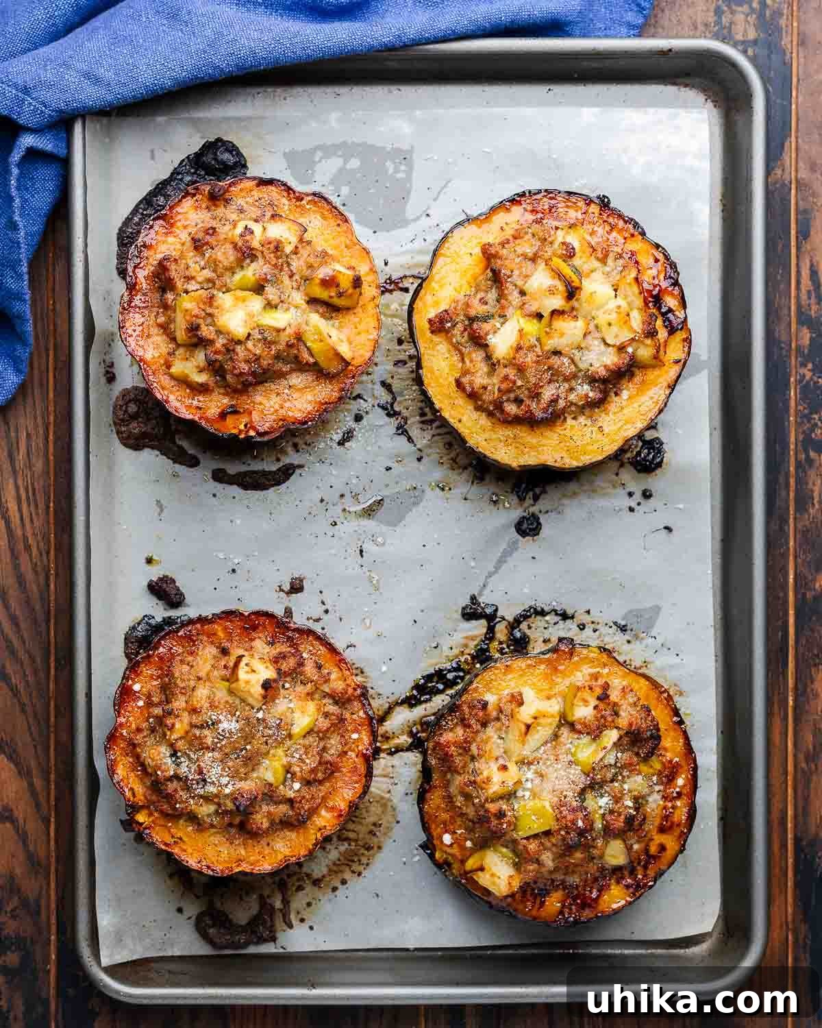 Savory Sausage and Acorn Squash Bake 9 Overhead shot of baking sheet with 4 stuffed acorn squash halves.