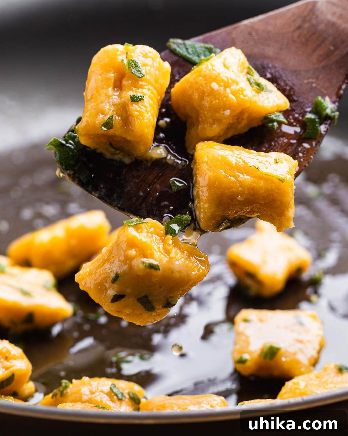 Podcast 21: Top Trader Joe's Fall Finds 2 Walnut spoon tossing butternut squash gnocchi in pan.