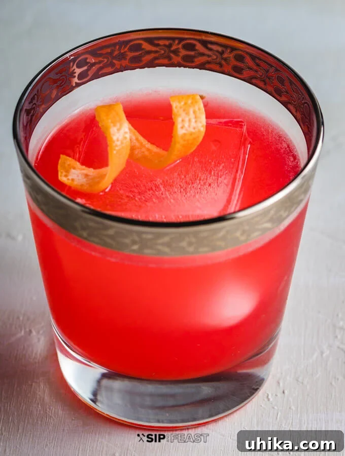 Grapefruit Gin Negroni Twist 4 A elegantly presented glass of Grapefruit Gin Cocktail, perfectly chilled and garnished with a delicate twist of grapefruit peel, emphasizing its refreshing appeal.