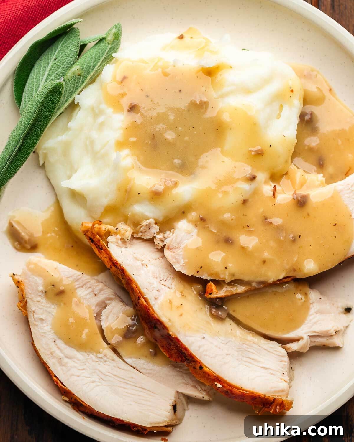 Flatter, Faster, Flawless: The Spatchcock Turkey 8 Sliced turkey with gravy in white plate.