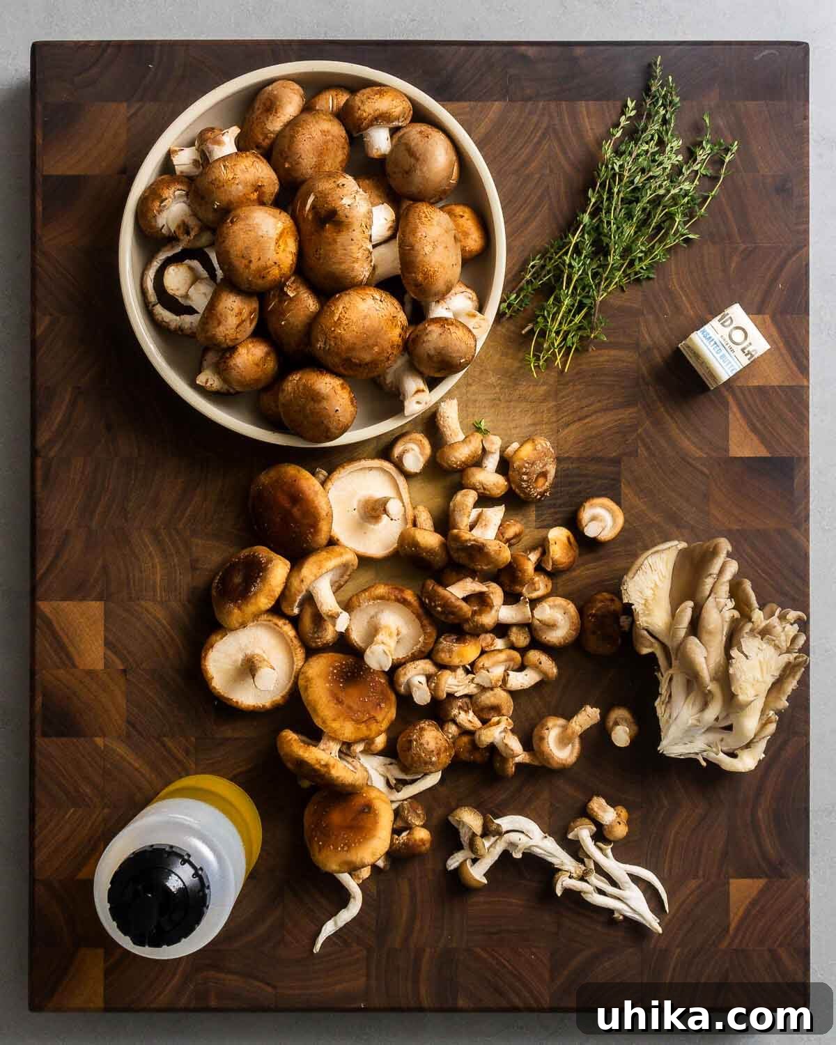 Golden Roasted Mushrooms 3 Ingredients shown: assorted mushrooms, thyme, butter, and olive oil.
