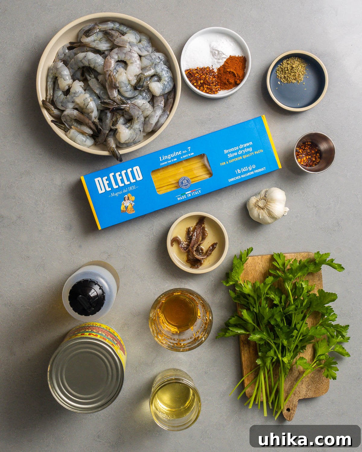 Fiery Fra Diavolo Shrimp Linguine 3 Ingredients shown: shrimp, spices, linguine, hot red pepper flakes, anchovies, garlic, olive oil, plum tomatoes, white wine, brandy, and parsley.