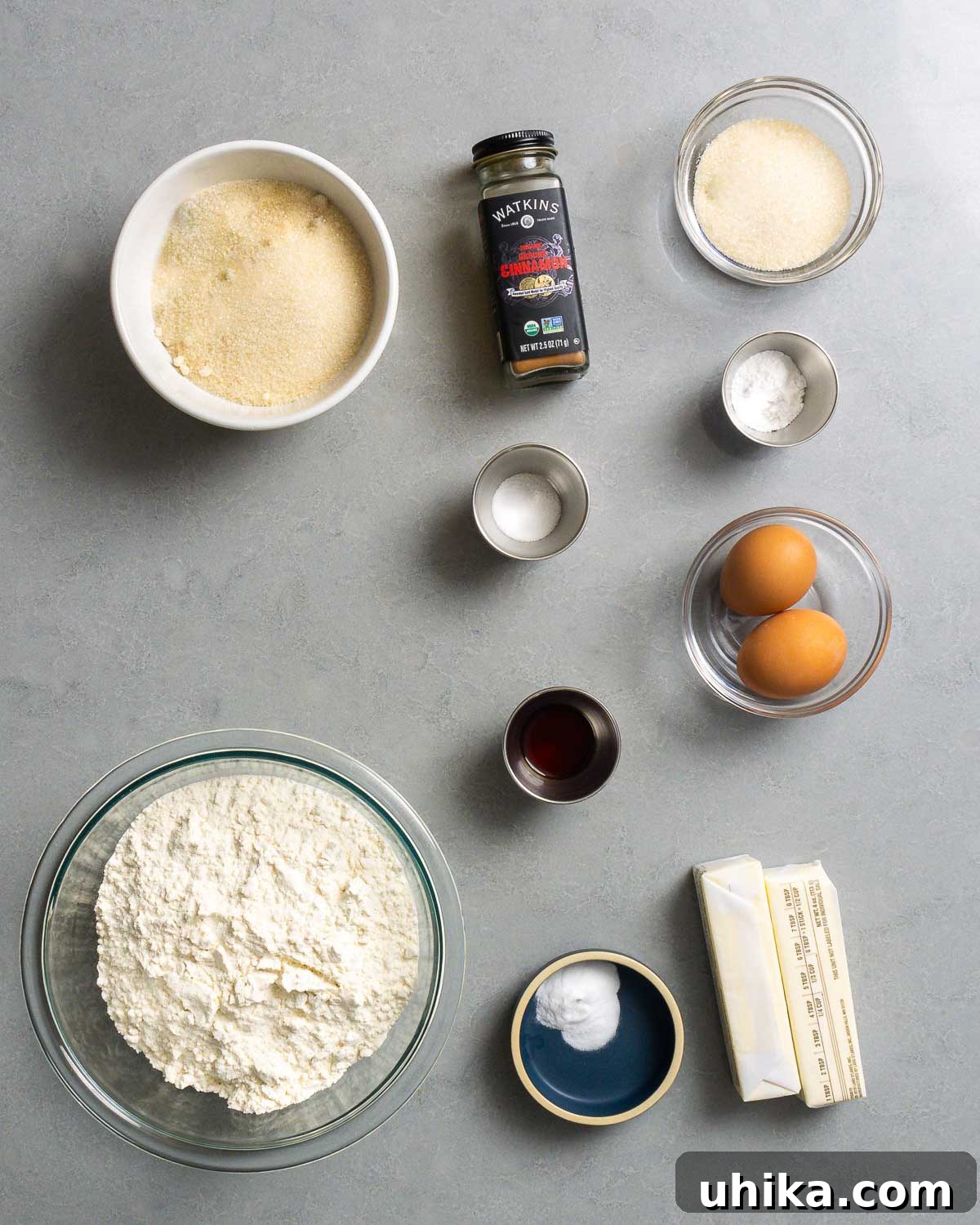 Melt In Your Mouth Fluffy Snickerdoodles 3 Ingredients shown: sugar, cinnamon, salt, cream of tartar, vanilla extract, eggs, flour, baking soda, and butter.
