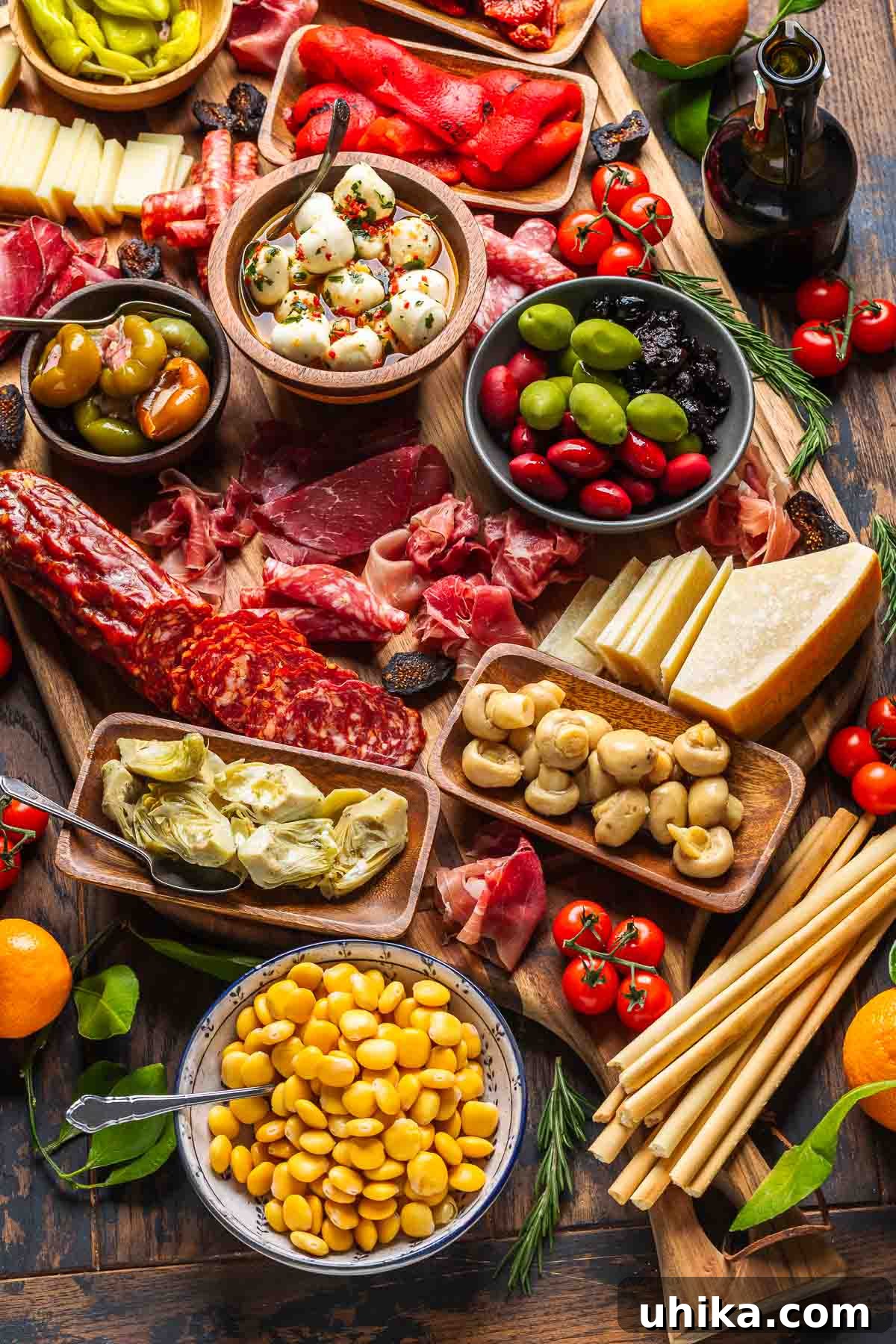 Crafting the Ultimate Antipasto Board 4 A close-up view of a meticulously arranged antipasto platter, showcasing cured meats, various cheeses, olives, pickled vegetables, lupini beans, and crisp breadsticks.
