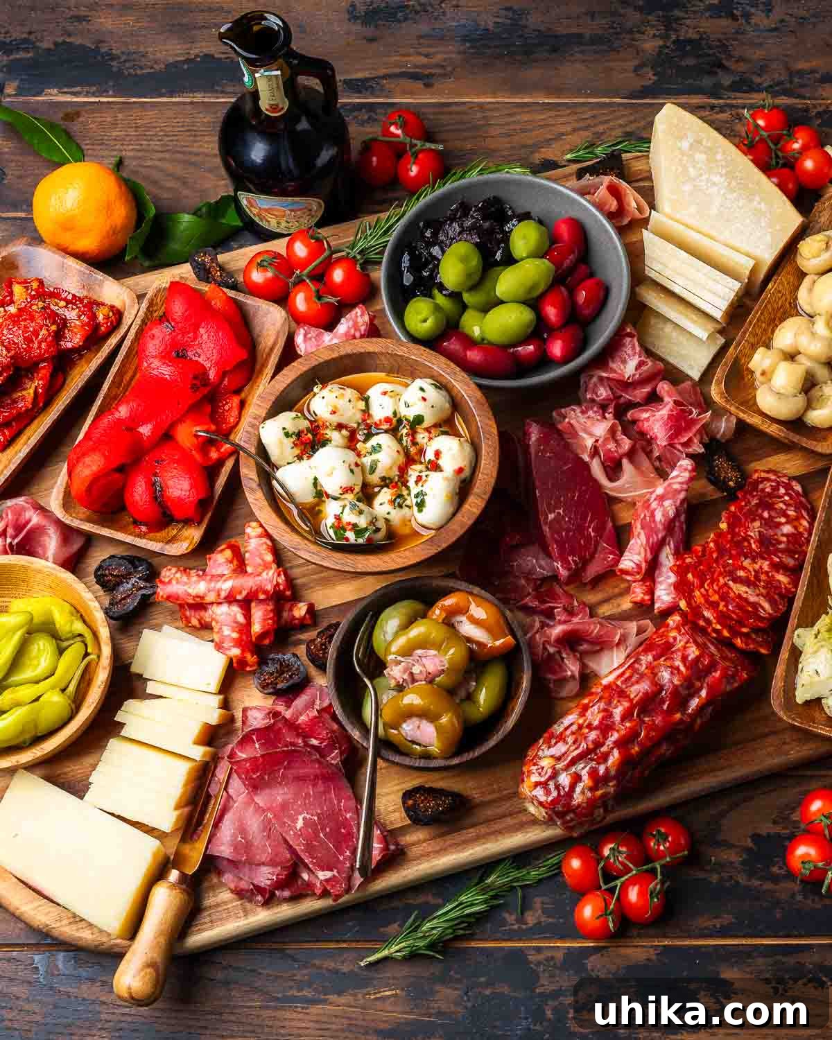 Crafting the Ultimate Antipasto Board 5 An inviting appetizer board featuring a delightful mix of cured meats, various cheeses, colorful pickled vegetables, sweet figs, and a drizzle of olive oil, perfect for sharing.