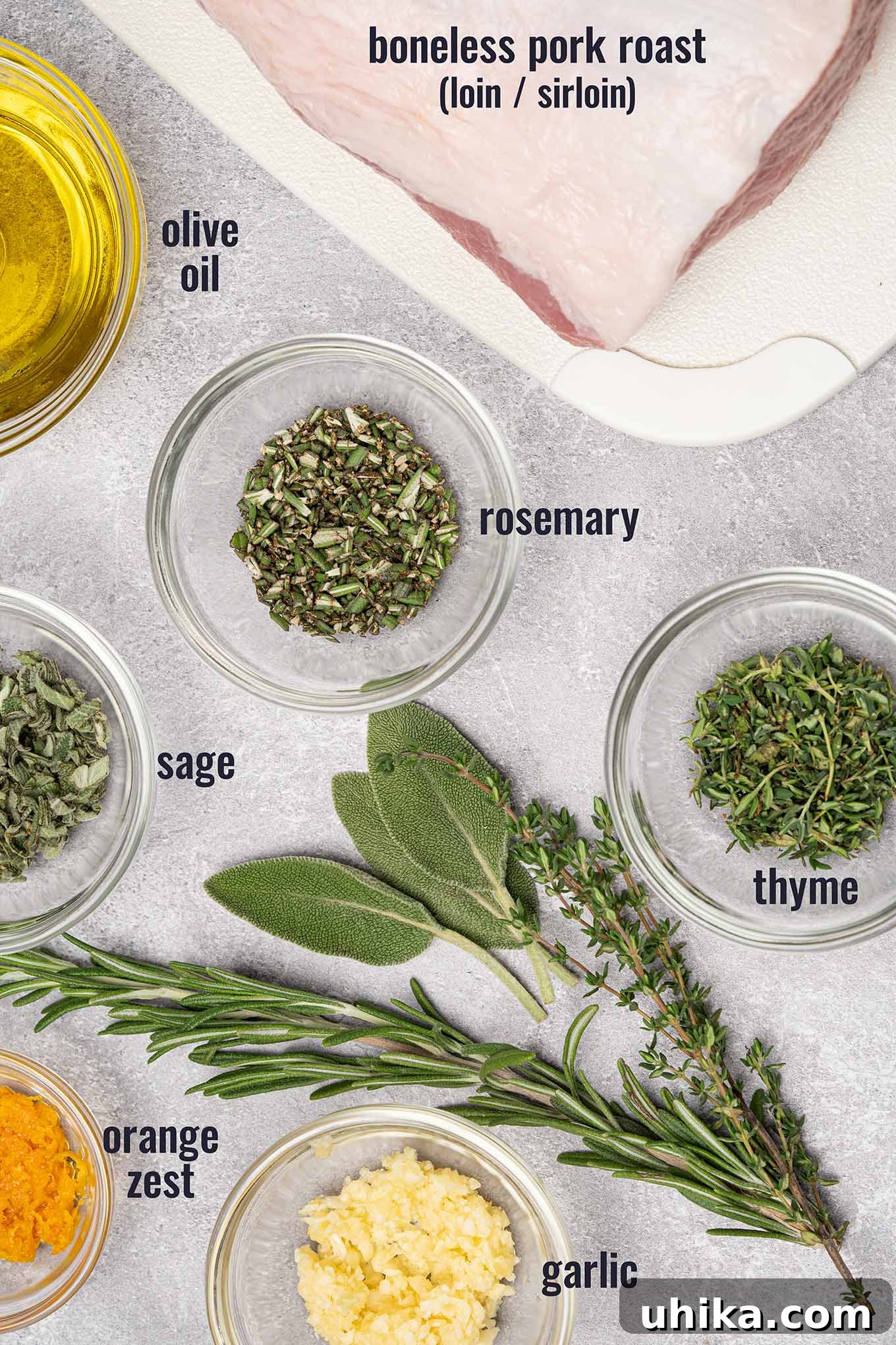 Golden Herb Crusted Pork Loin 3 Ingredients for garlic and herb crusted boneless pork roast including fresh sage, rosemary, and thyme, garlic, orange zest, and olive oil.
