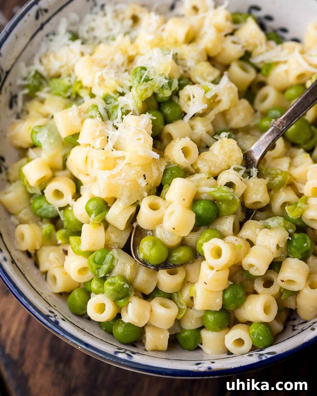 Closeup shot of blue and white bowl with pasta e piselli.