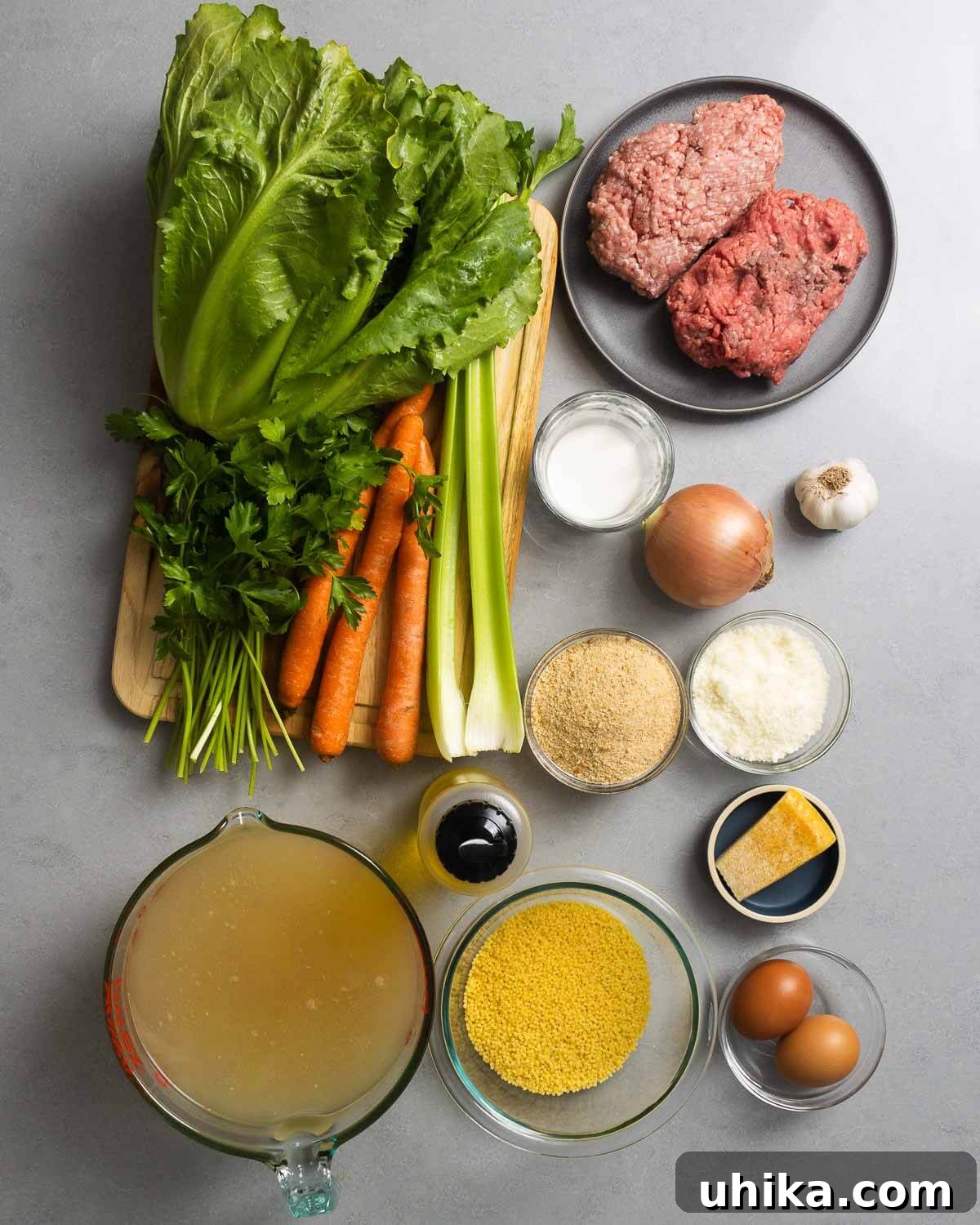 Italian Wedding Feast Soup 3 Ingredients shown: escarole, parsley, carrots, celery, ground beef and pork, milk, onion, garlic, breadcrumbs, pecorino, parmesan rind, olive oil, chicken stock, acini di pepe, and eggs.