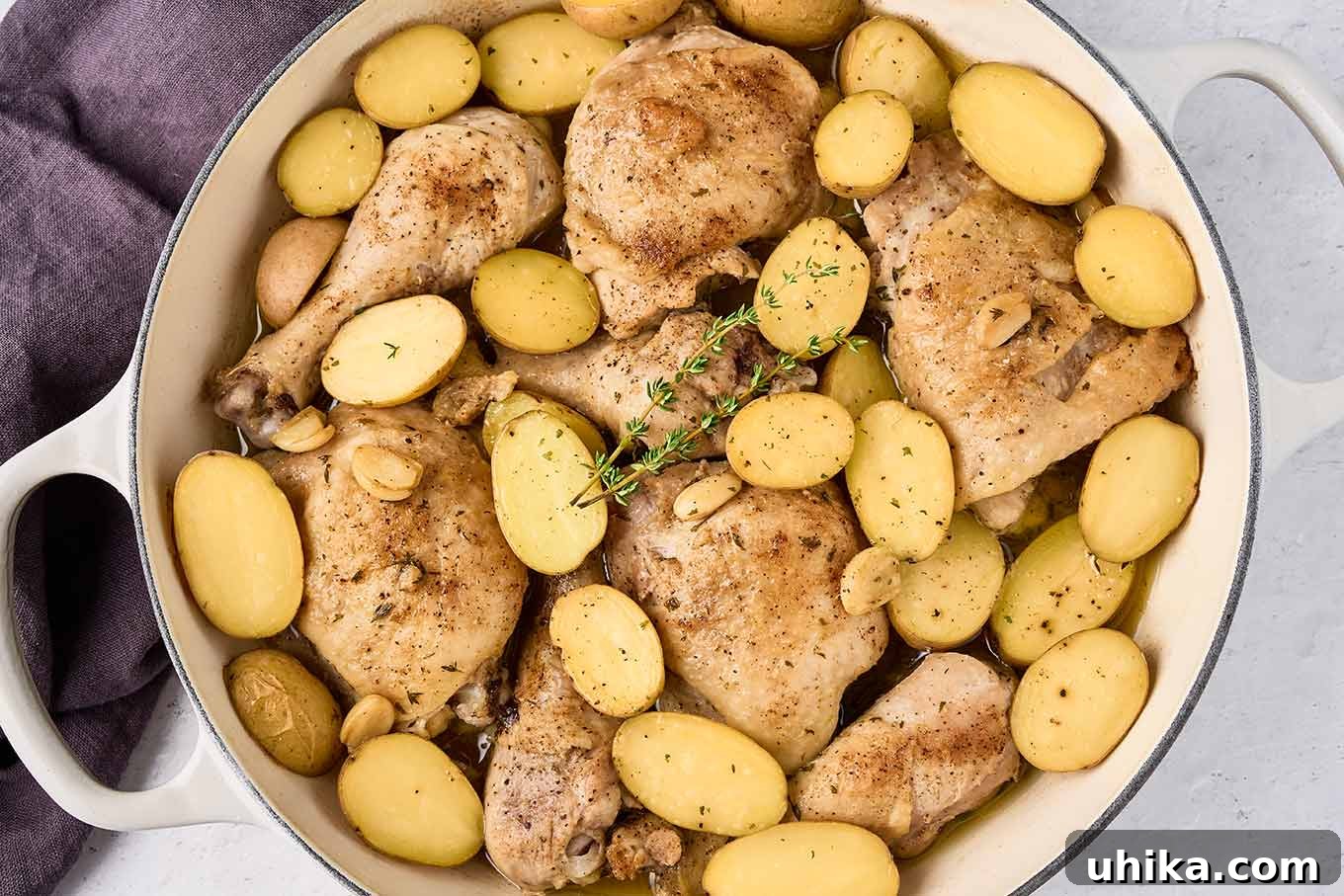 Hearty Braised Chicken and Potatoes 7 Browned chicken thighs and drumsticks topped with halved baby potatoes and garlic before braising.