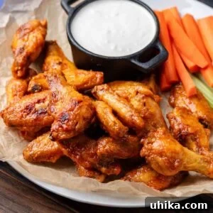 Buffalo Wing Perfection 9 Platter of oven baked buffalo wings with blue cheese, carrots, and celery.