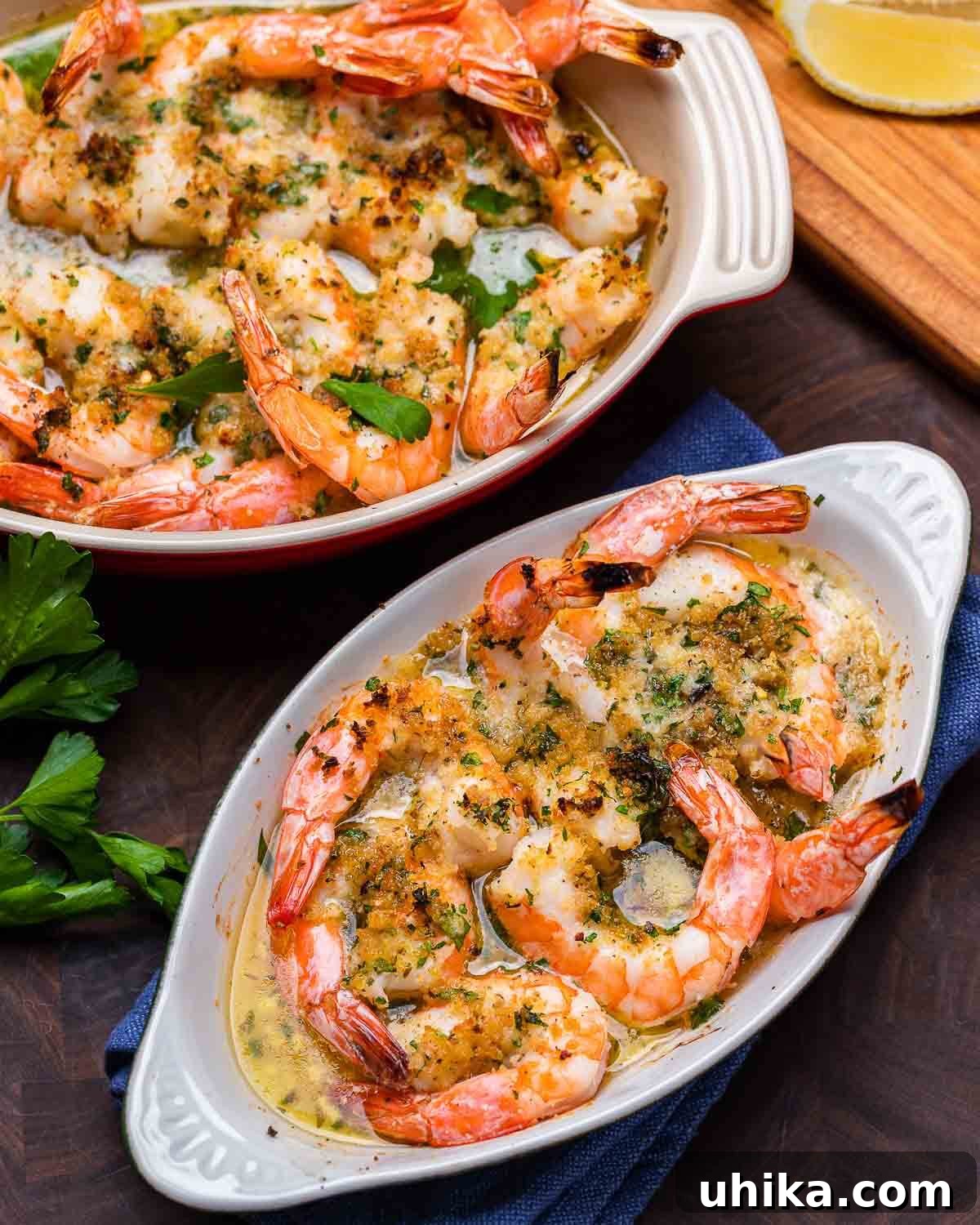 Zesty Oregano Shrimp 2 Large and small dish of baked shrimp oreganata on walnut cutting board.