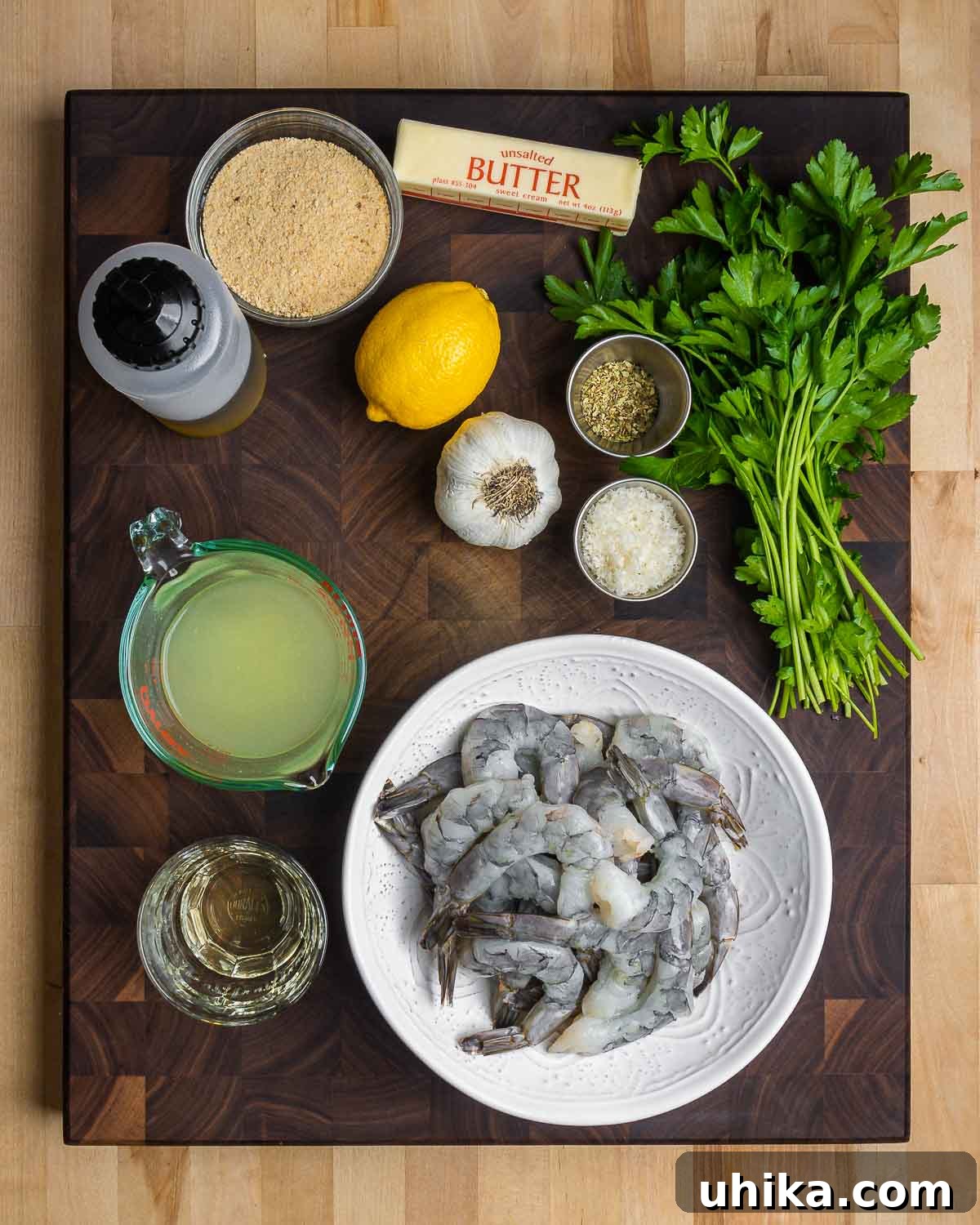 Zesty Oregano Shrimp 3 Ingredients shown: breadcrumbs, olive oil, lemon, garlic, parmesan, oregano, parsley, chicken stock, white wine, and shrimp.