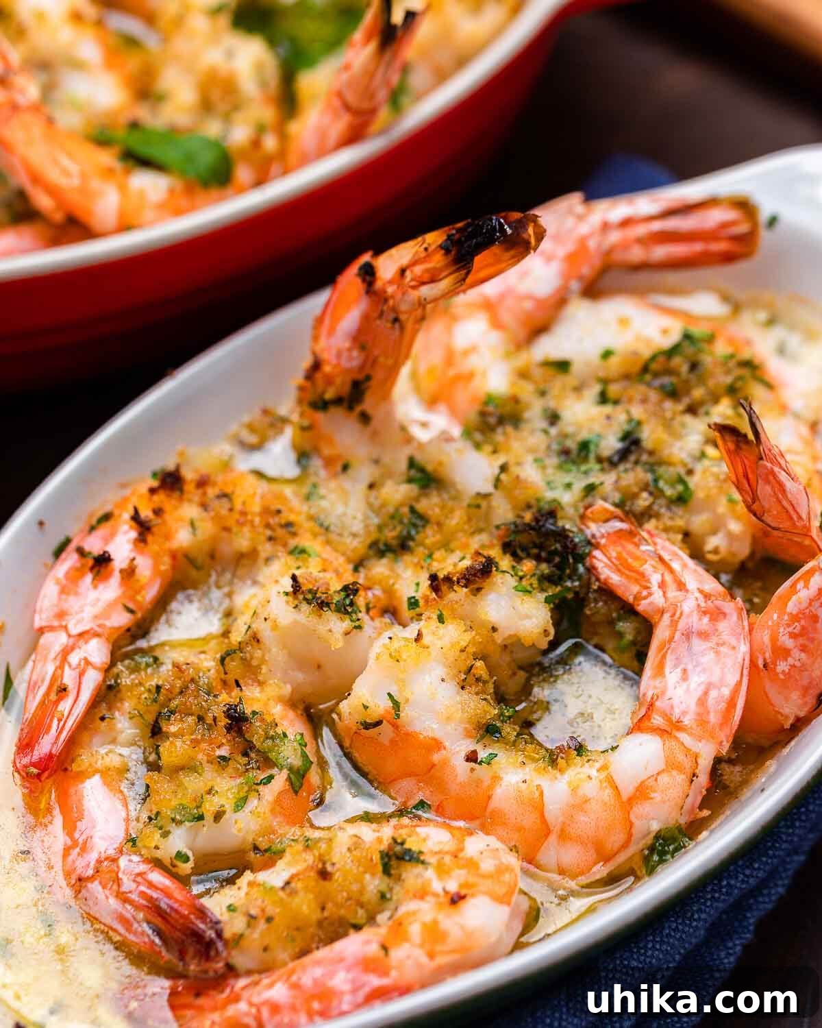 Zesty Oregano Shrimp 6 Closeup shot baked shrimp with breadcrumbs in white plate.