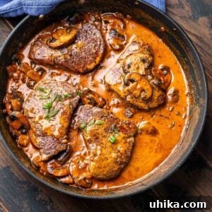 Vintage Flambéed Steak Diane 10 Steak Diane in a black pan, showcased as the featured image for the recipe card.