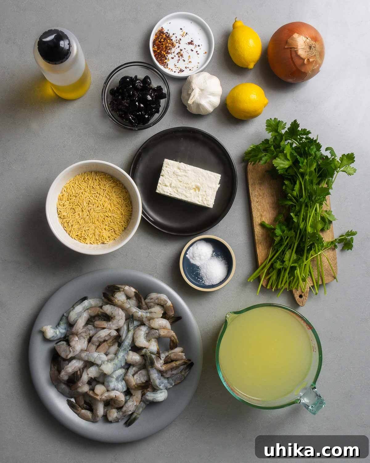 Mediterranean Shrimp and Feta Orzo 3 Ingredients shown: olive oil, oil-cured olives, red pepper flakes, garlic, lemons, onion, orzo, feta, salt, baking soda, parsley, shrimp, and chicken stock.
